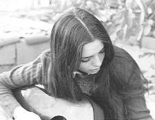 Kinda playing the guitar. 